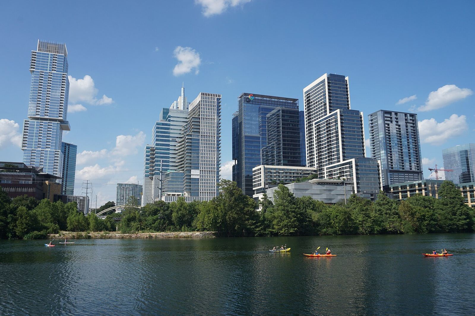 Kayakers on Lady Bird Lake below the downtown Austin skyline