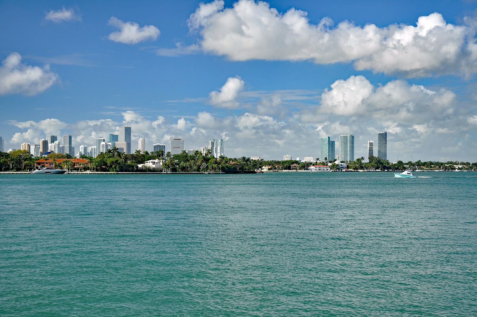 Downtown Miami skyline seen across the turquoise water of Biscayne Bay on a sunny day