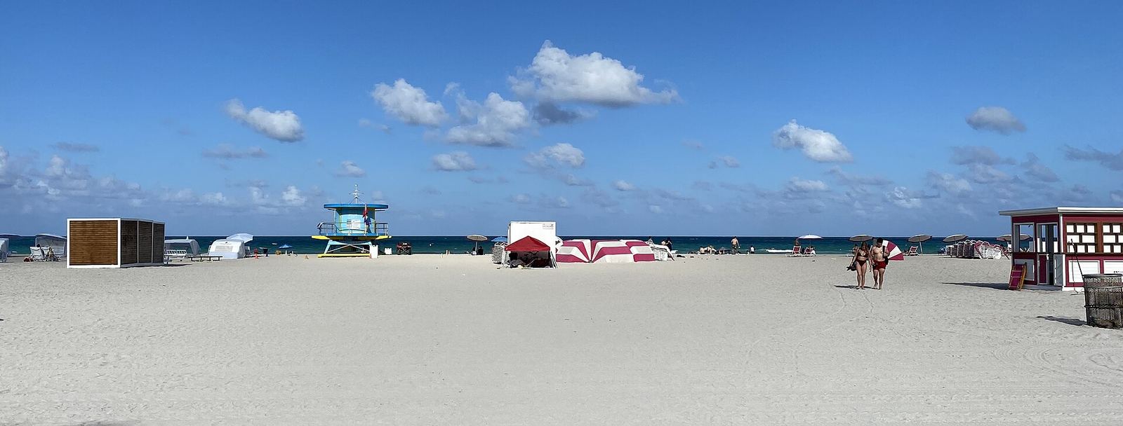 Wide sandy beach in Miami Beach with a lifeguard tower and the ocean on the horizon