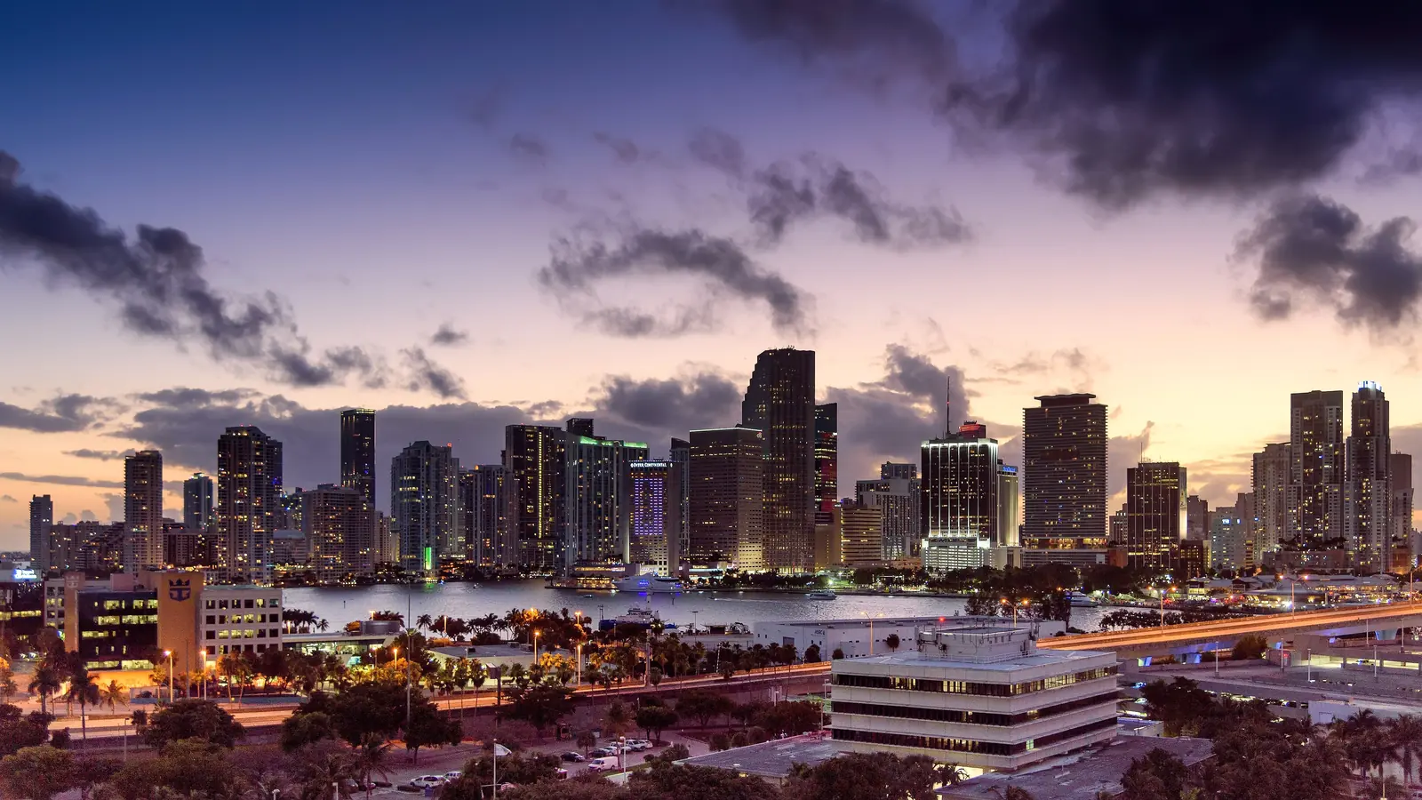 Downtown Miami skyline at sunset under purple clouds