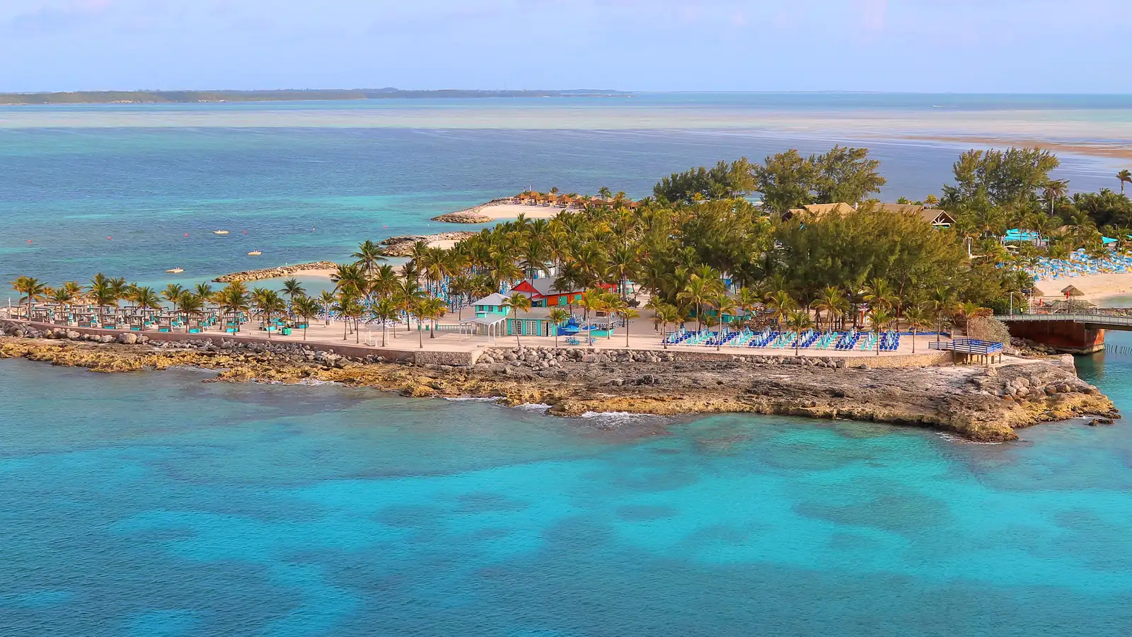 Sandy beach with lounge chairs and umbrellas on a private island in The Bahamas