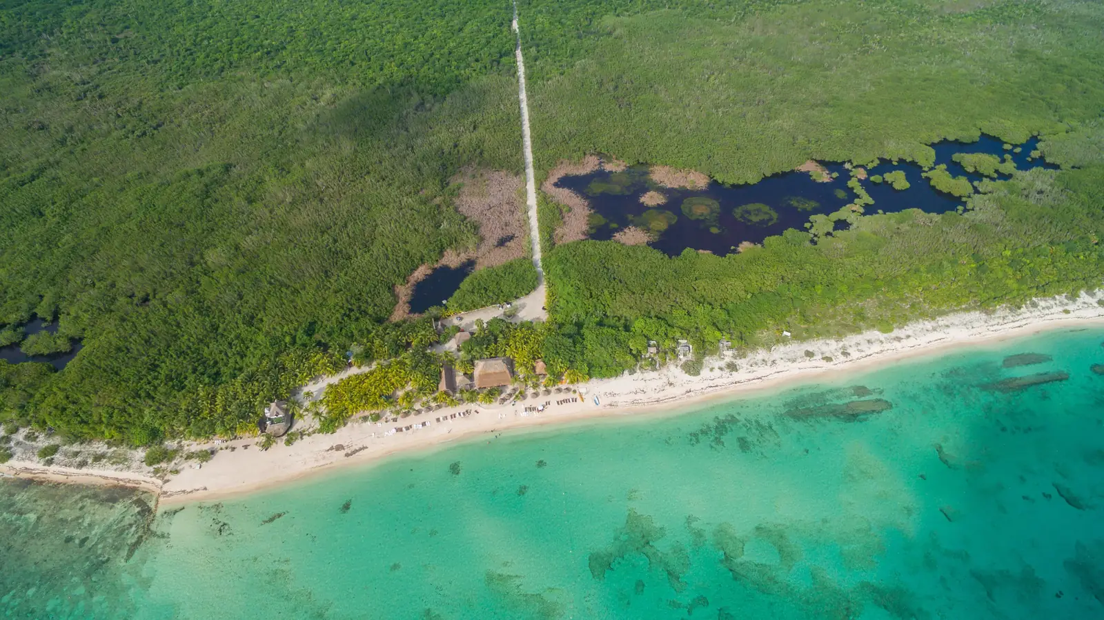 Aerial view of a white sand beach and clear turquoise water on Cozumel, Mexico