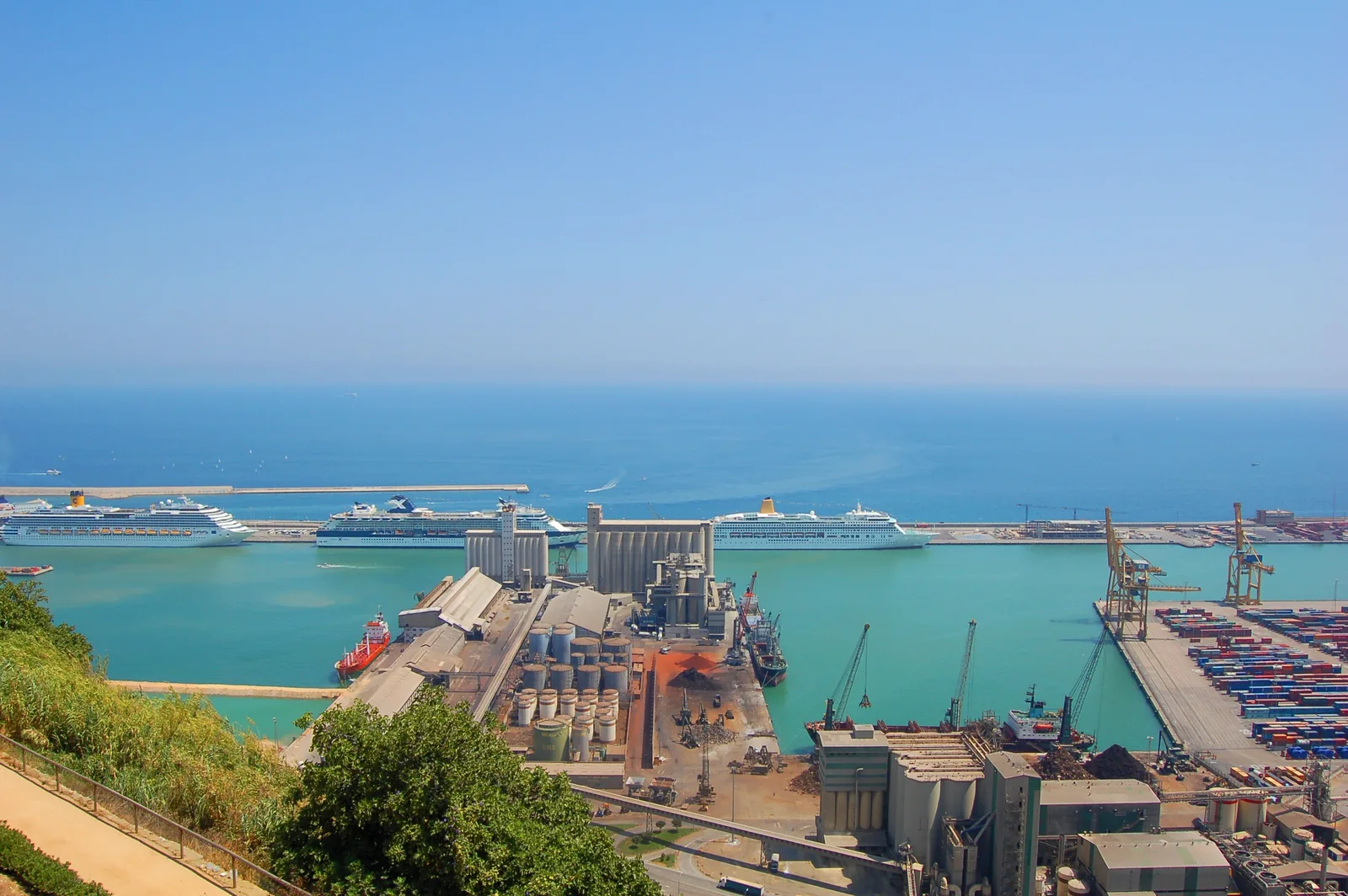 Cruise terminal buildings and docked ships at the Port of Barcelona on a sunny day