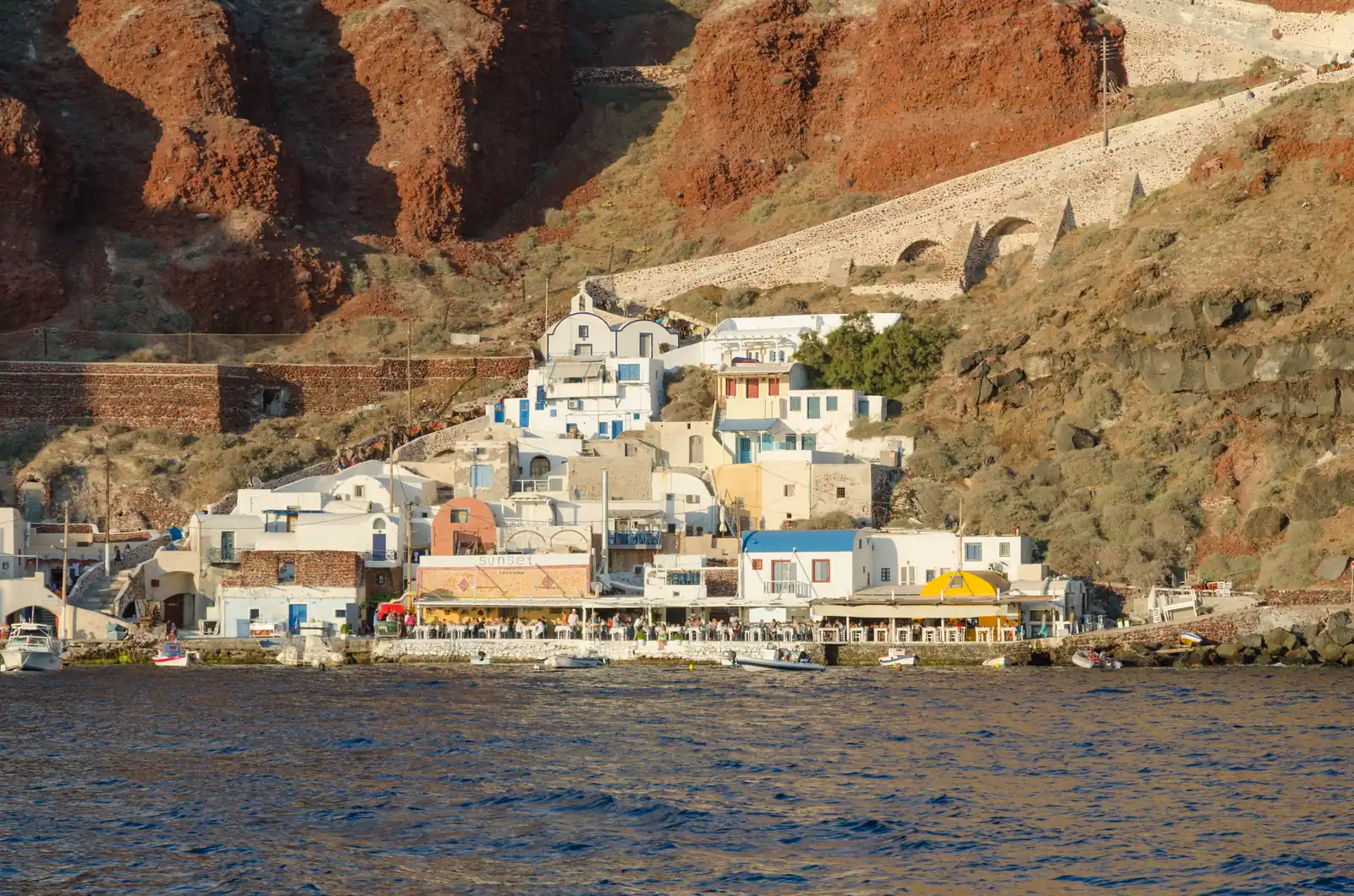 White houses on the cliffs above Ammoudi harbor in Oia, Santorini