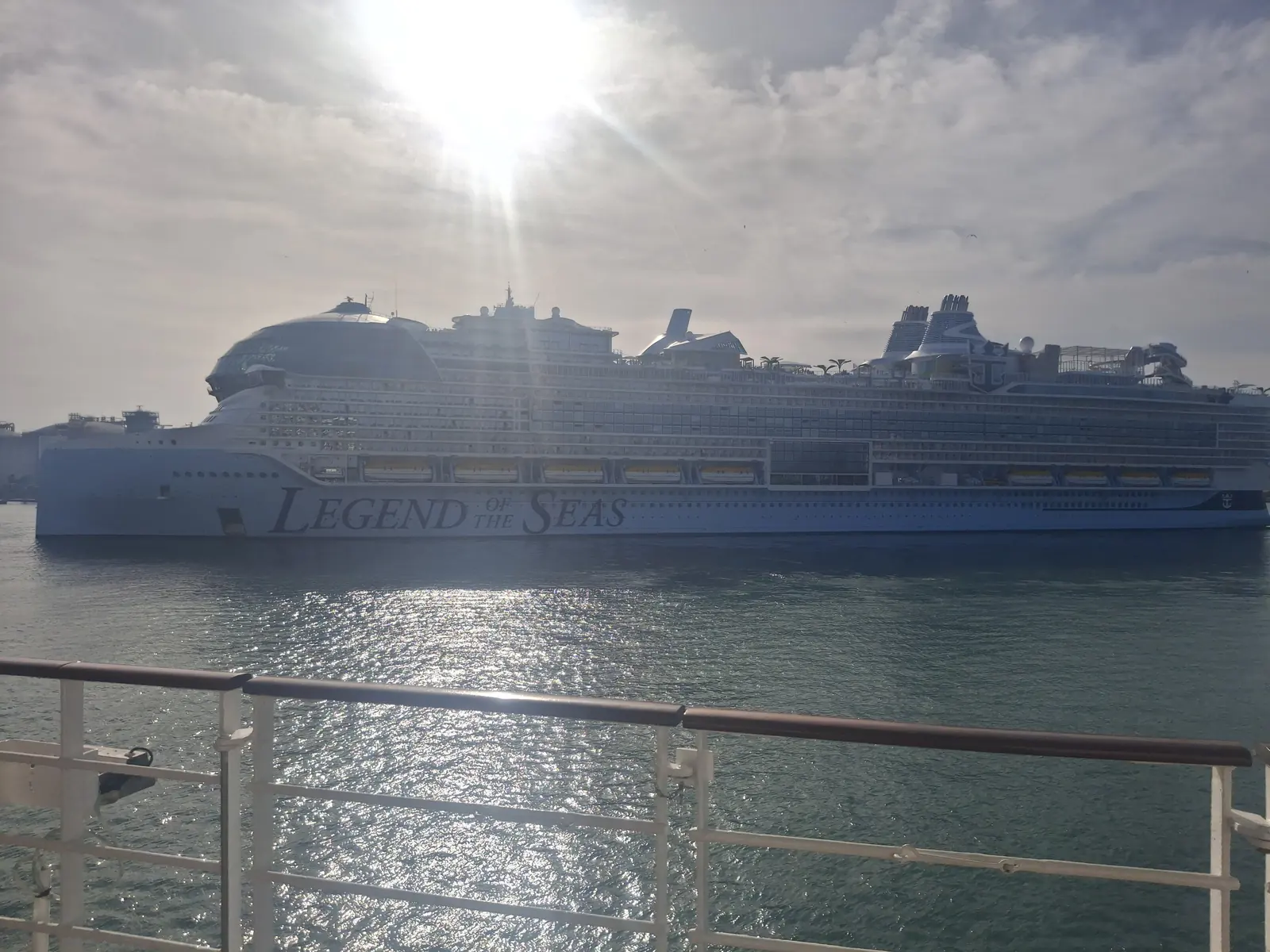 Large cruise ship leaving the port of Barcelona on a hazy, sunny day