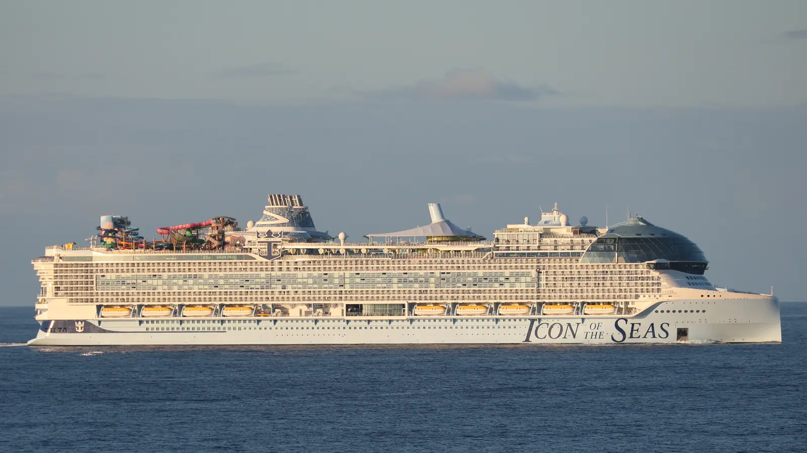 Side view of a large cruise ship at sea showing its stacked cabin decks