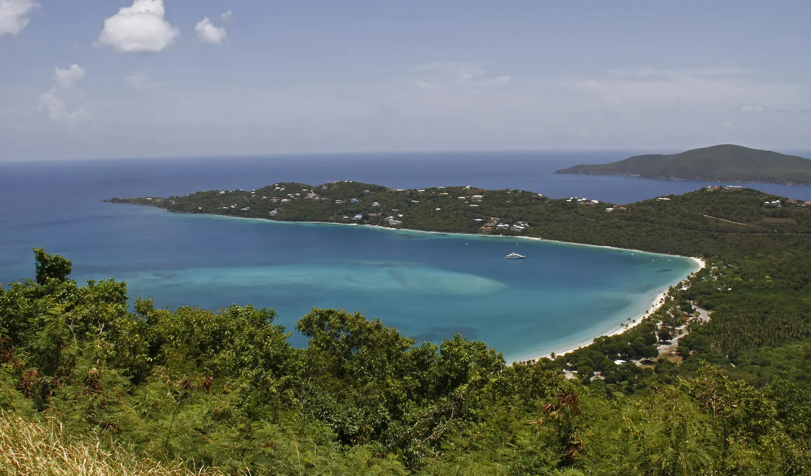 Curving white sand beach and turquoise water of Magens Bay, St. Thomas