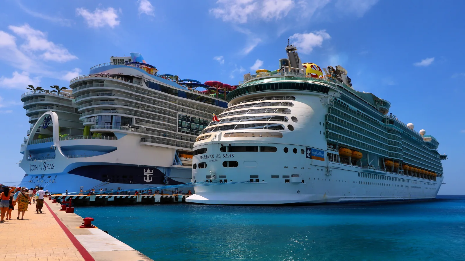 Two large cruise ships docked side by side at a pier in Cozumel, Mexico