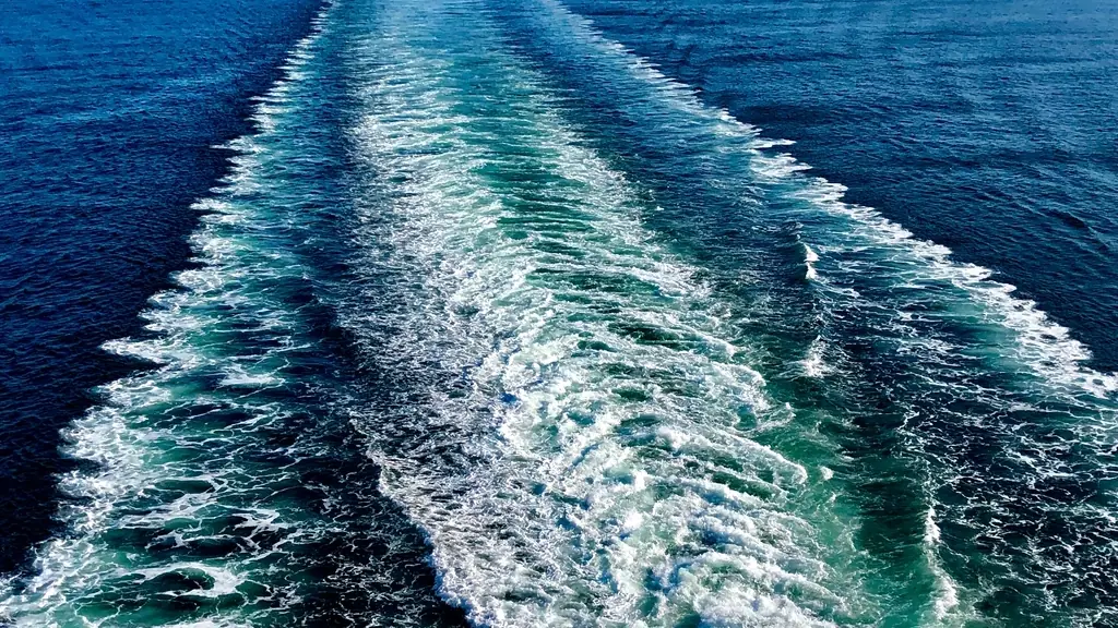 White wake trailing across deep blue open sea